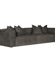 A modern four seater sofa upholstered in dark charcoal gray leather, featuring matching throw pillows, shown against a plain white background.
