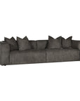 A dark gray upholstered leather sofa with a low, wide silhouette, wide armrests, and six matching throw pillows, shown against a plain white background.