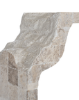 Duna Console Natural Fossil Stone close-up highlighting the flowing contours of the sculptural leg and contrasting smooth and textured stone finishes.