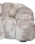 Melo Sofa Lush Pearl close-up showing the rounded armrest, plush polyester upholstery and distinctive padded panel construction.