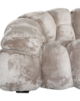 Melo Sofa Lush Pearl close-up showing the rounded armrest, curved seams and plush polyester fabric with subtle tonal variations.