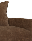 Close-up of a brown textured fabric sofa cushion and matching armrest against a plain white background.