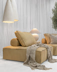 Sabi Table Lamp displayed on a Bedu Side Table alongside the Maui Sofa beneath a pair of Senah Pendants.