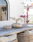 Cala Outdoor Dining Chairs with woven detailing and neutral cushions styled around a rustic timber outdoor dining table.