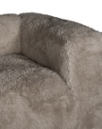 Close up detail of the Harlow Sofa one seater highlighting the rounded arm, deep seat cushion and biscuit faux fur upholstery with a soft textured finish.
