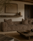 Harlow three seater sofa in chocolate with a plush textured finish styled in a warm Mediterranean inspired living room with rustic timber accents.