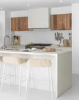 Hotham Barchairs arranged along a kitchen island with Ukoko Vases displayed behind and the Mayi Bowl styled on the benchtop.
