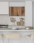Hotham Barchairs at a white kitchen island with Ukoko Vases and the Mayi Bowl styled throughout the neutral kitchen setting.