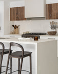 Loki Barstools in Espresso arranged as a trio at a white kitchen island, highlighting their curved timber frames and dark seats