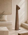 Nhara floor lamp with a sculptural paper mache lamp and angled shade styled in a warm Mediterranean inspired living room with soft natural light.