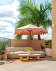 Oasis sofa paired with Maaru planter in a sunlit rooftop lounge with soft curved seating warm brick textures and lush greenery creating a relaxed outdoor retreat