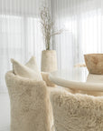 Hamilton Dining Chairs in Fur Luxe beside the Salalah Dining Table in High Gloss Vanilla, with Nusa Palm and Muhle planters completing the setting