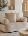 Soneva sofa in Dolce featuring soft curved arms and plush textured upholstery styled in a serene Mediterranean inspired living room.