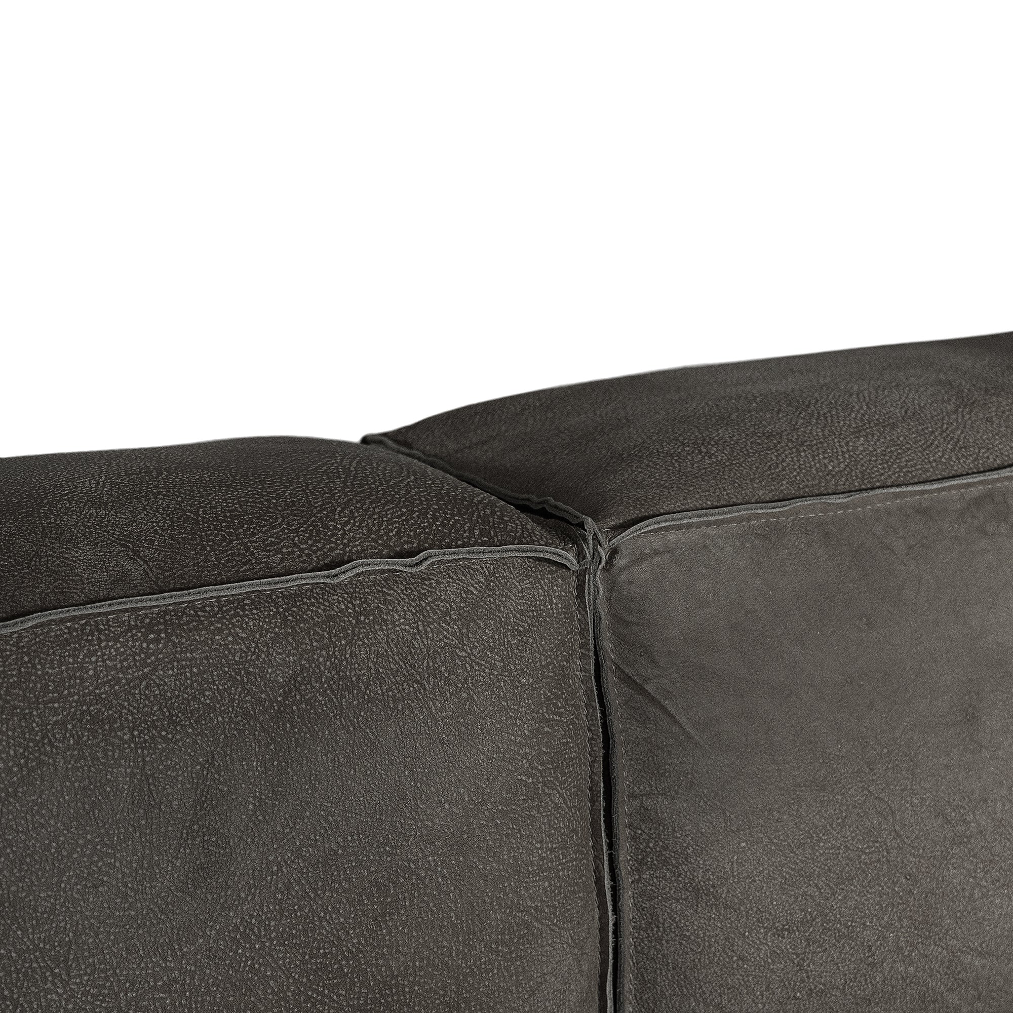 Close-up of a dark gray textured leather or sofa corner with visible stitching and a clean white background.