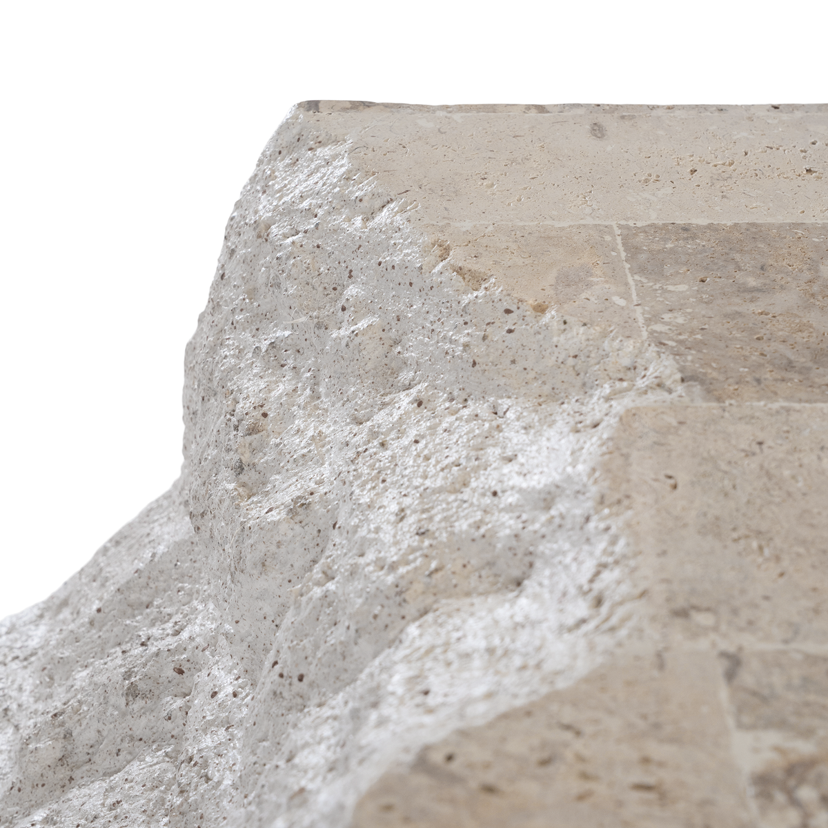 Duna Console Natural Fossil Stone close-up highlighting the irregular sculptural surface, natural pitting and subtle variations in the pale stone finish.