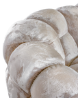 Melo Sofa Lush Pearl close-up highlighting the curved upper armrest, segmented back cushions and soft, light-reflecting upholstery.