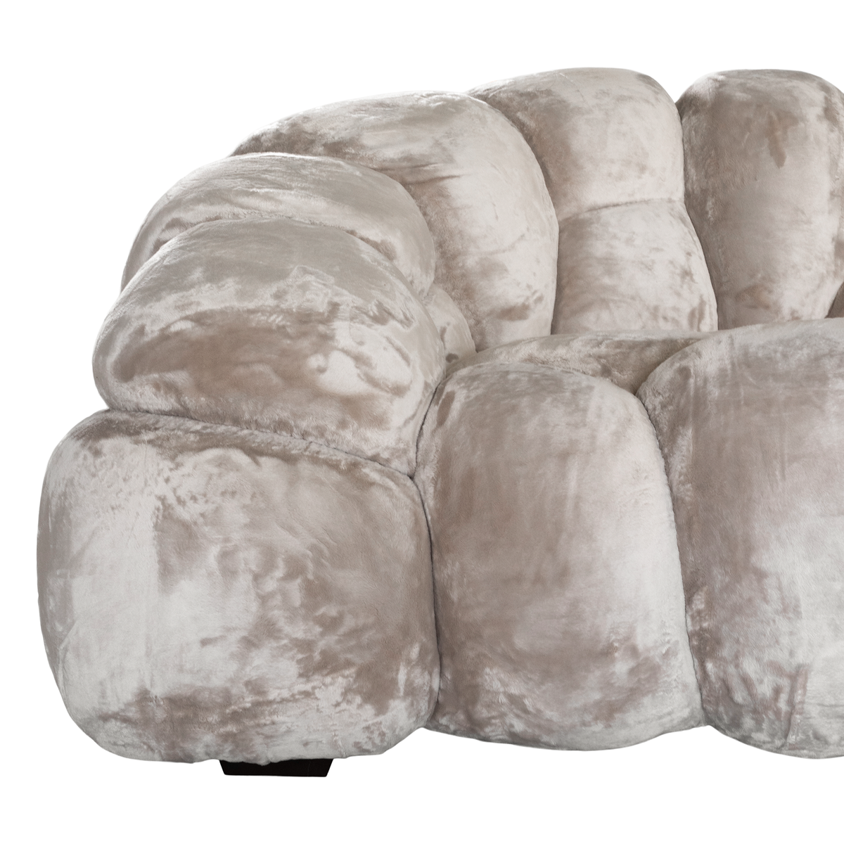 Melo Sofa Lush Pearl close-up showing the rounded armrest, curved seams and plush polyester fabric with subtle tonal variations.