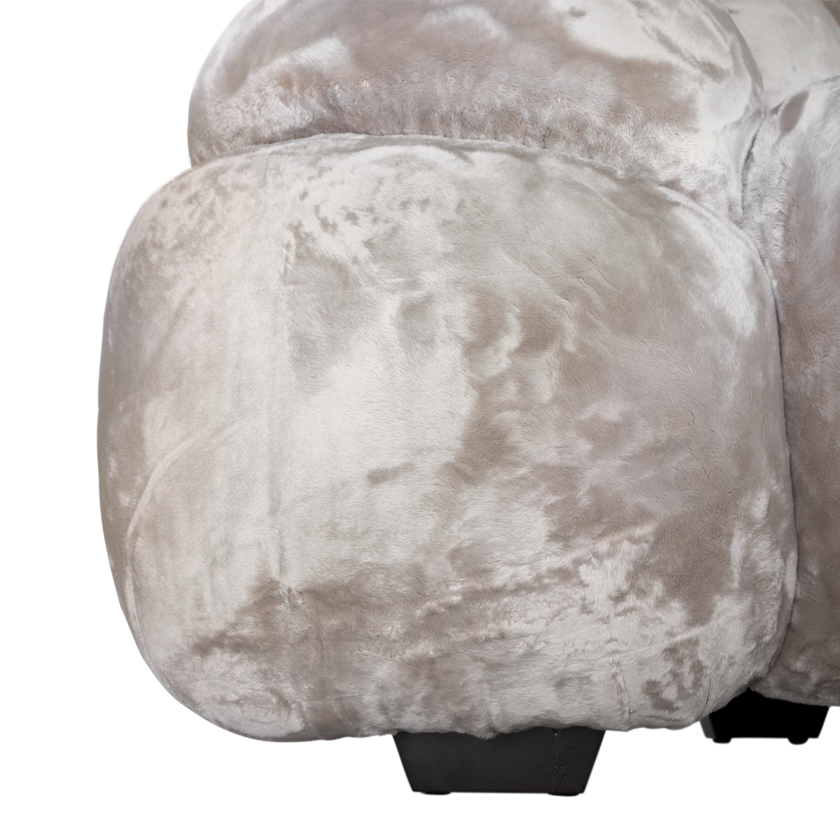 Melo Sofa Lush Pearl close-up highlighting the rounded lower upholstery panel, soft fabric texture and contrasting dark timber-look foot.