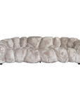 Melo Sofa Lush Pearl three seater front view, featuring an enveloping curved silhouette, oversized padded sections and soft pearl upholstery.