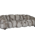 Melo Sofa Smokey Quartz three seater angled view, featuring oversized rounded upholstery panels, a curved backrest and soft taupe-grey tones.