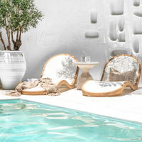 Uniqwa Collections Serene outdoor furniture Modern luxury poolside lounge chairs with curved teak wooden frame, paired with a sculpted side table for a Mediterranean-inspired retreat. Perfect for stylish, high-end outdoor living.
 