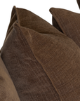 Close-up of brown textured throw pillows on a white background.