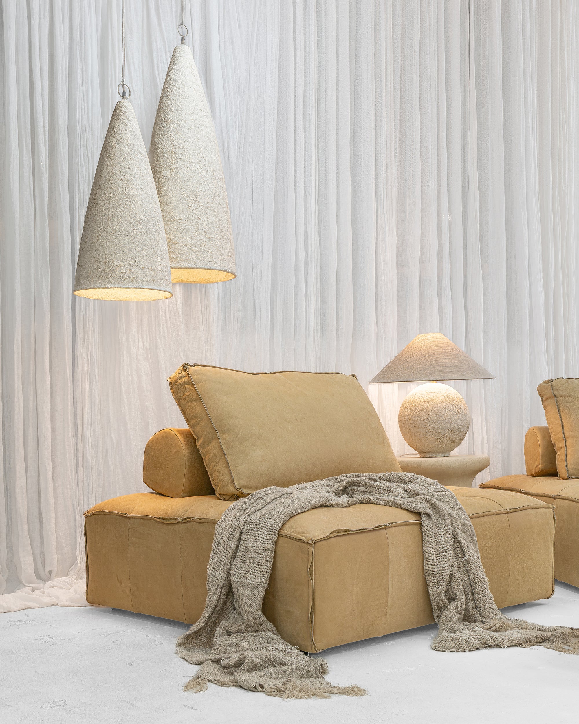 Maui Sofa modules styled with Bedu Coffee Table, Bedu Side Table, Sabi Table Lamp and Senah Pendants in a soft neutral interior.