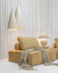 Maui Sofa modules styled with Bedu Coffee Table, Bedu Side Table, Sabi Table Lamp and Senah Pendants in a soft neutral interior.