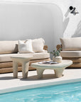 Bedu and Satori Collections styled poolside with woven outdoor seating and sculptural organic shaped tables.