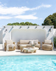 Bedu and Satori Collections styled together in a bright poolside setting with woven outdoor seating and sculptural tables.