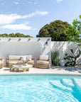 Bedu and Satori Collections styled in a relaxed poolside outdoor setting with woven seating and sculptural tables.