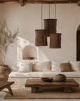 Bhodi pendant light cluster with handcrafted textured shades suspended above a timber coffee table in a warm Mediterranean inspired living room.