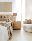 Bulu Bedside handcrafted from reclaimed pine styled with a coral-inspired lamp in a modern neutral bedroom setting