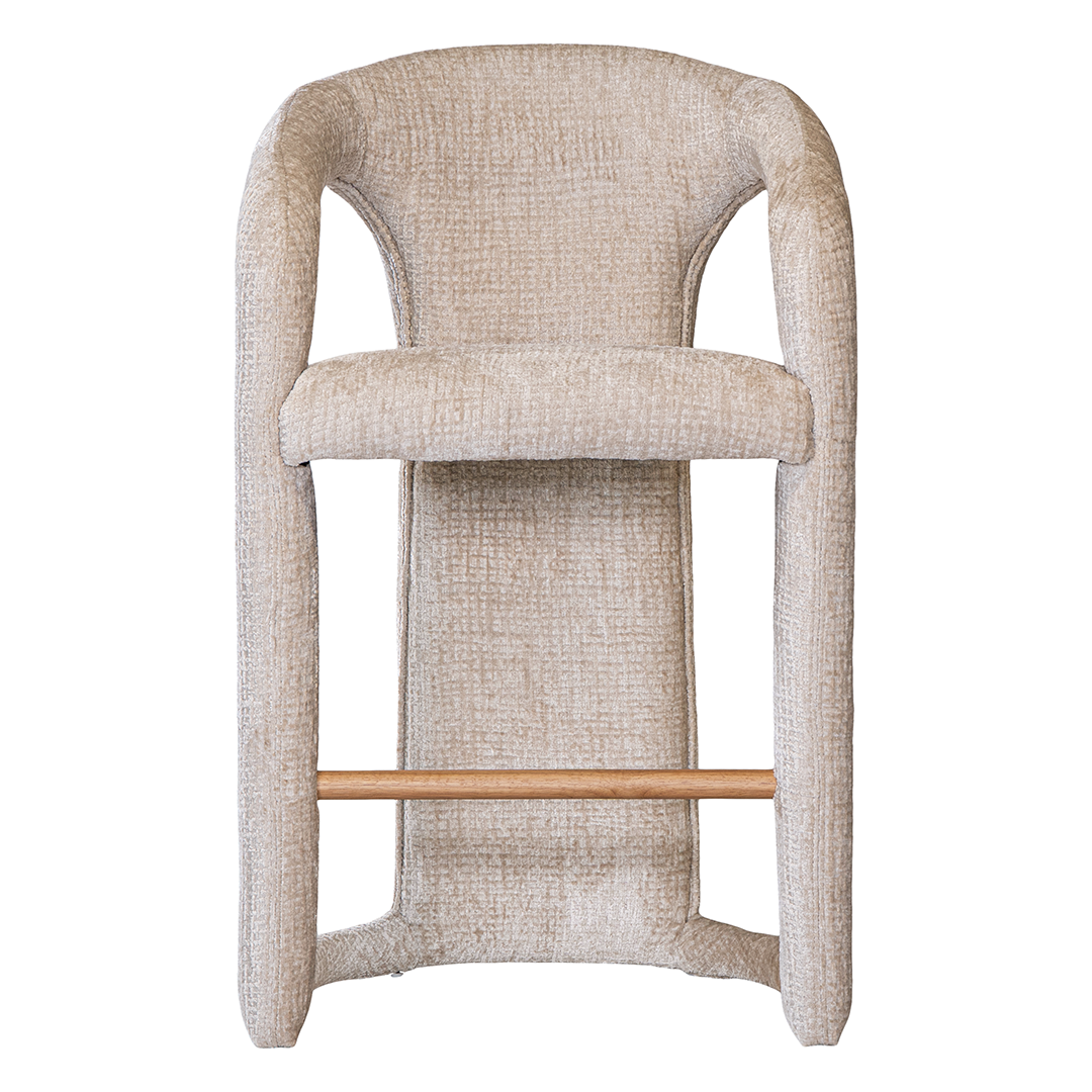 Fikile bar chair in sand mirage upholstery with a sculptural curved frame and integrated timber footrest detail.
