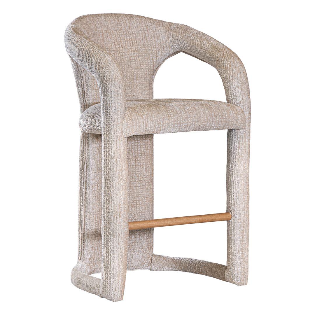 Fikile bar chair in sand mirage upholstery with a sculptural curved frame and integrated timber footrest detail.