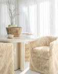 Hamilton Dining Chairs in Fur Luxe surround the Salalah Dining Table in High Gloss Vanilla, styled with sculptural planters and a Bloom Mug