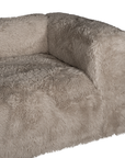 Close up detail of the Harlow Sofa highlighting the rounded arm, deep seat cushion and biscuit faux fur upholstery with a soft textured finish.