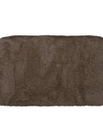 Side view of the Harlow three seater sofa upholstered in chocolate faux fur highlighting the low profile design, rounded silhouette and plush textured finish.