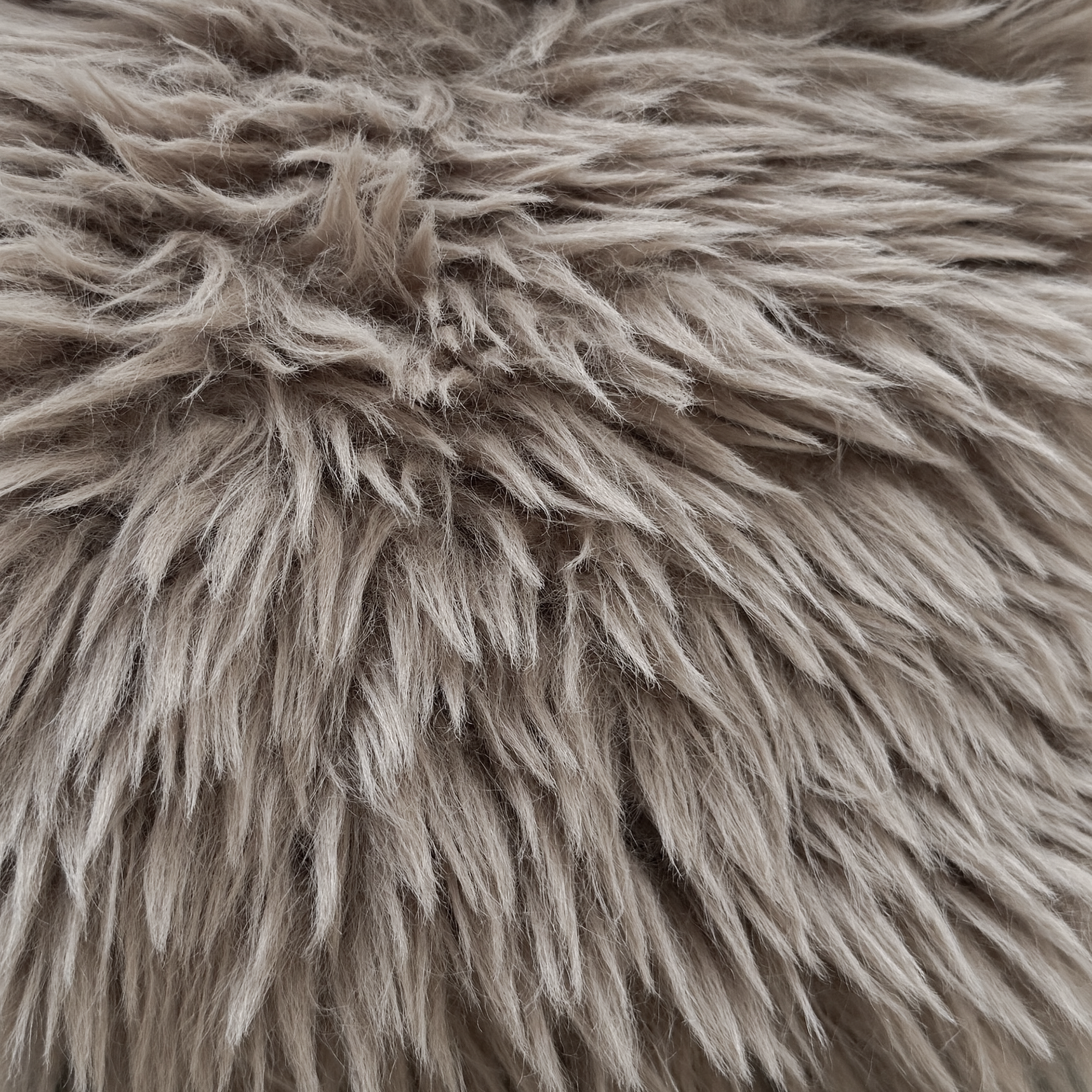 Close up detail of the Harlow Sofa one seater showcasing the long pile biscuit faux fur upholstery with a soft, richly textured finish.