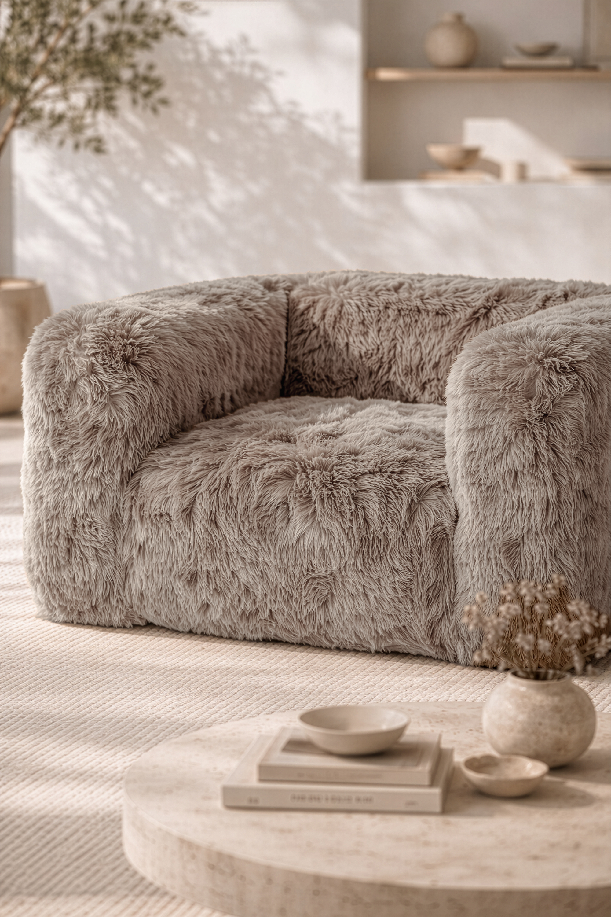 Close up of the Harlow one seater sofa in Biscuit featuring plush faux fur upholstery and rounded contemporary form in a softly styled neutral living space.