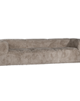 Harlow Sofa three seater upholstered in biscuit faux fur with a low profile silhouette, generous curved arms and deep cushioned seating shown from the front.