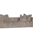 Harlow Sofa three seater upholstered in biscuit faux fur styled with matching faux fur cushions, featuring a low profile silhouette, curved arms and deep cushioned seating.