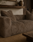 Close up of the Harlow three seater sofa in chocolate showcasing its plush textured upholstery in a warm Mediterranean inspired living room.