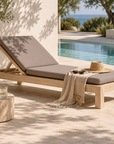 Harper sun lounger in taupe with an adjustable backrest beside a swimming pool in a relaxed Mediterranean style outdoor setting.