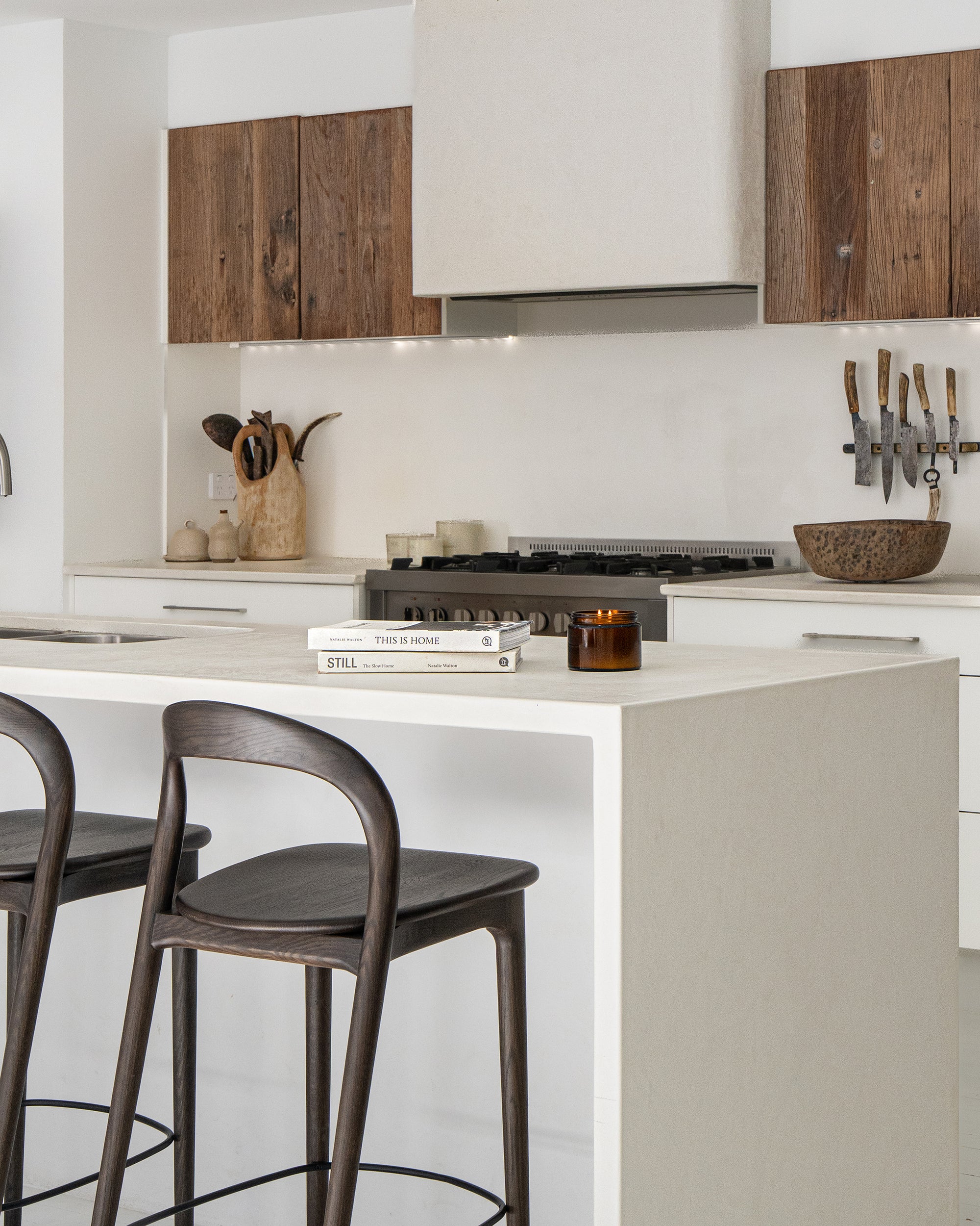 Loki Barstools in Espresso arranged as a trio at a white kitchen island, highlighting their curved timber frames and dark seats