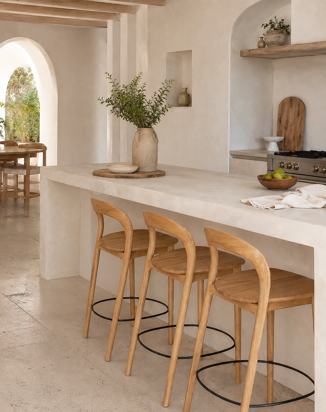 Loki Oak Bar Chairs in Natural styled around a sculptural stone island in a warm Mediterranean inspired kitchen