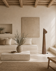 Nhara floor lamp with angled shade styled in a warm Mediterranean inspired living room with soft natural light.