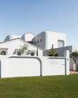 Nusa Palm Planter with an olive tree styled at the entrance of a white Mediterranean inspired home.
