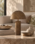 Samrah Table Lamp Dark Roast Large with sculptural dome shade and textured finish, styled on a stone coffee table in a neutral living room.