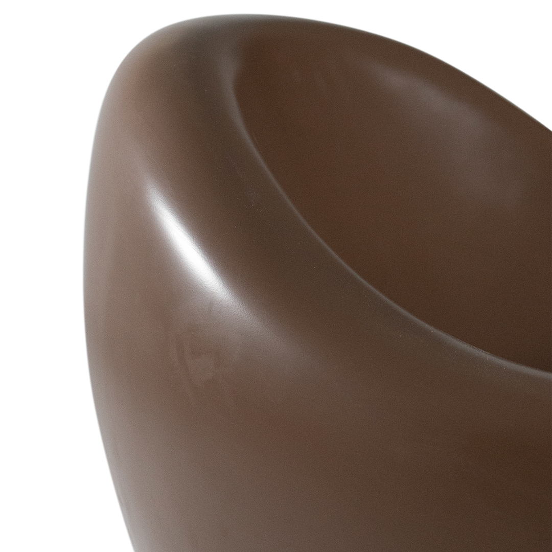 Santorini occasional chair in chocolate featuring a smooth sculptural form with rounded curves and a deep comfortable seat.